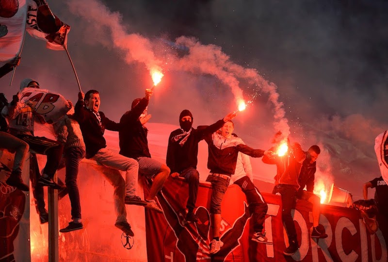 Supporters jumping on fences